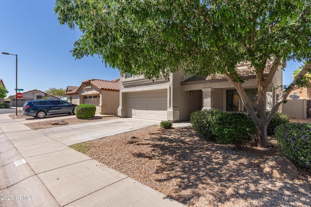 view of front of house featuring stucco siding, driveway, and a tiled roof