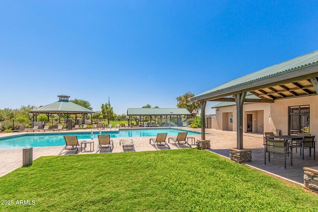 pool with a patio area, a gazebo, fence, and a yard