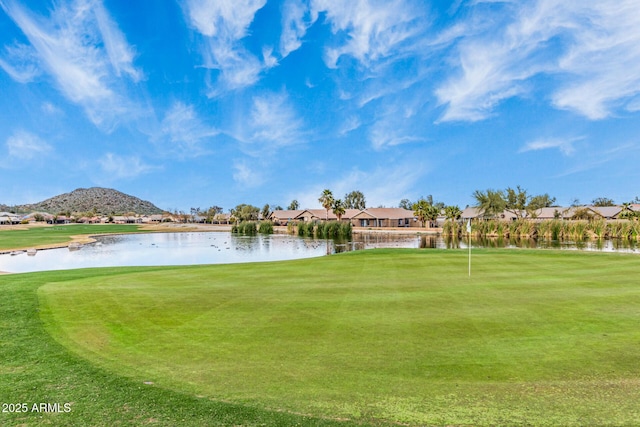 view of community with a water and mountain view, a residential view, and view of golf course