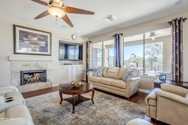 living room featuring dark hardwood / wood-style floors and a tile fireplace