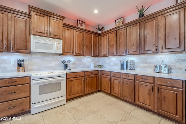 kitchen with white appliances, light tile patterned floors, and tasteful backsplash