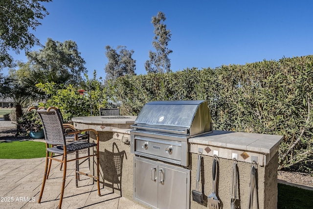 view of patio featuring a bar, a grill, and area for grilling