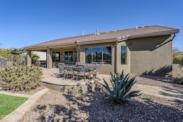 back of property featuring a patio area and ceiling fan