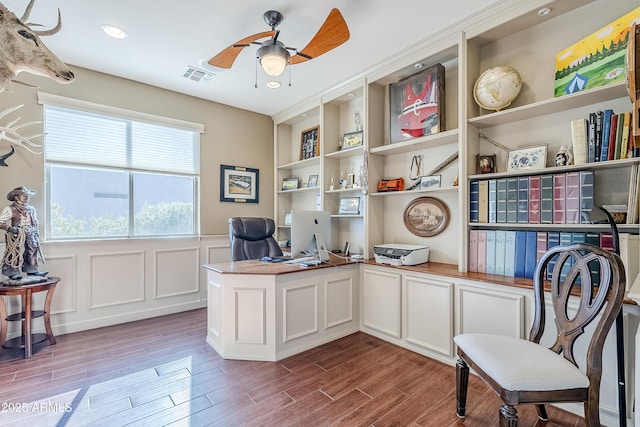 home office with ceiling fan and built in features