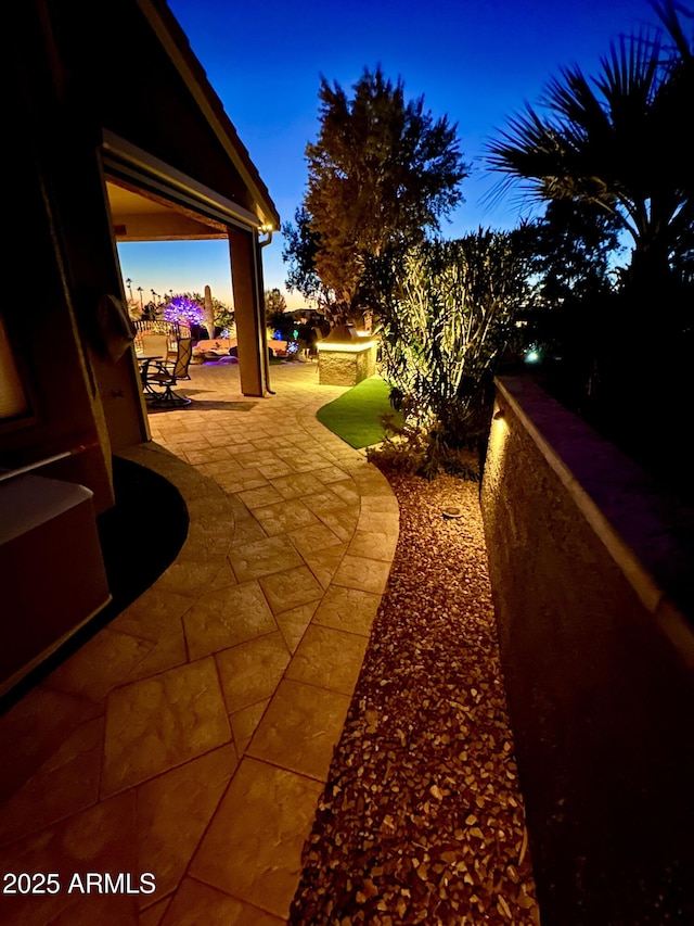 view of patio terrace at dusk