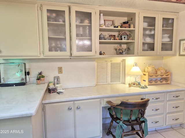 1118 E Orangewood Ave, Phoenix, AZ 85020 - kitchen with light countertops and glass insert cabinets