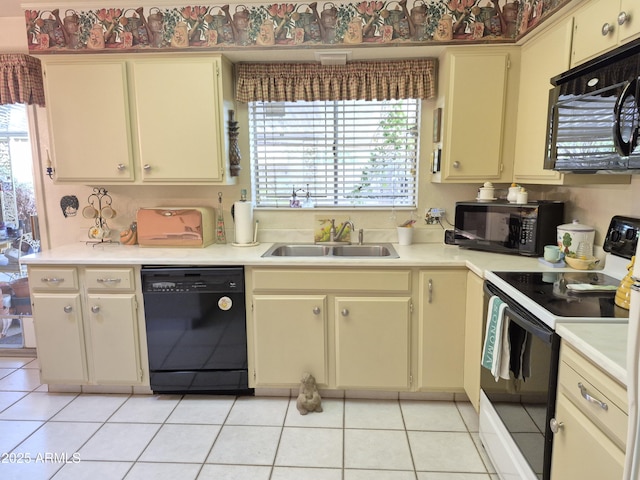 1118 E Orangewood Ave, Phoenix, AZ 85020 - kitchen with black appliances, cream cabinets, a sink, and light countertops
