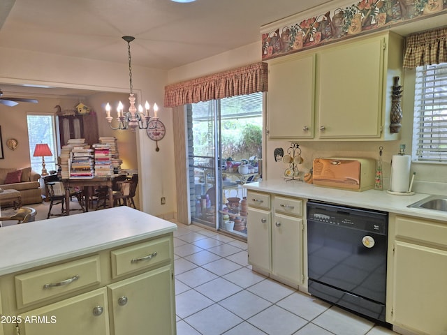1118 E Orangewood Ave, Phoenix, AZ 85020 - kitchen featuring black dishwasher, light countertops, open floor plan, light tile patterned floors, and hanging light fixtures