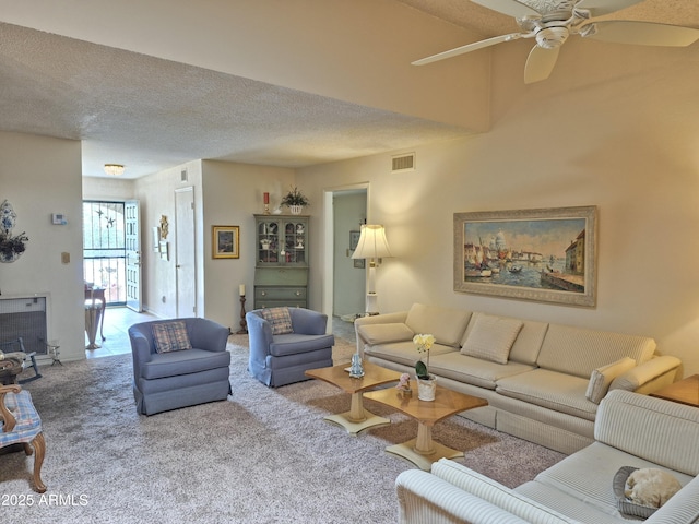 1118 E Orangewood Ave, Phoenix, AZ 85020 - carpeted living room featuring a ceiling fan and a textured ceiling