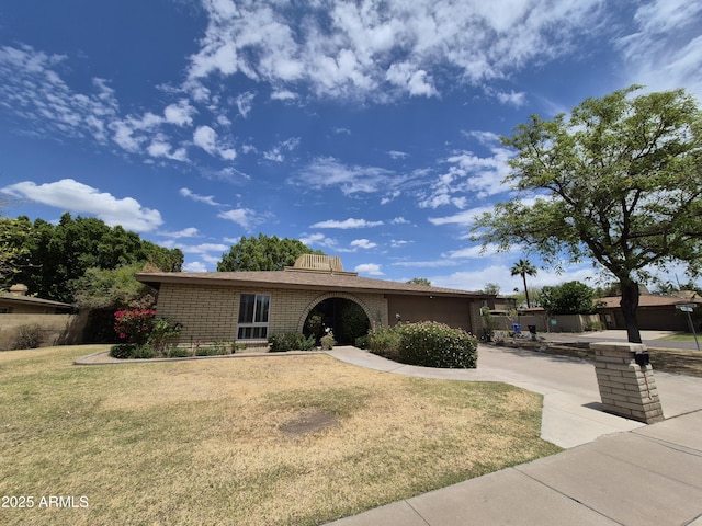 1118 E Orangewood Ave, Phoenix, AZ 85020 - ranch-style house featuring brick siding, a front lawn, and an attached garage