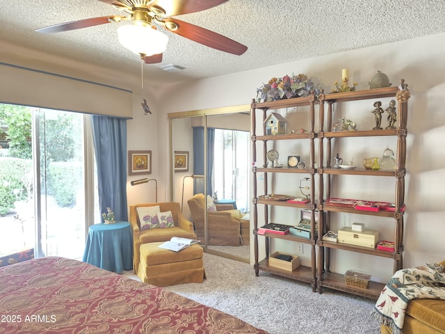 1118 E Orangewood Ave, Phoenix, AZ 85020 - carpeted bedroom featuring a textured ceiling, a closet, and a ceiling fan