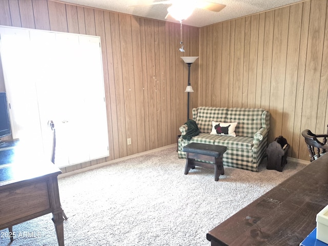 1118 E Orangewood Ave, Phoenix, AZ 85020 - living area featuring a ceiling fan, wooden walls, and carpet flooring
