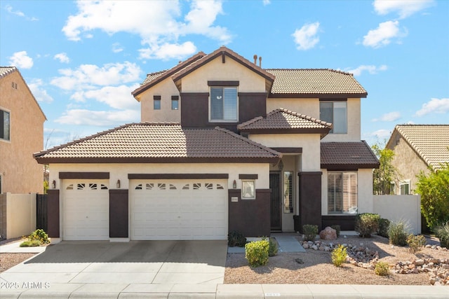 mediterranean / spanish-style house featuring driveway, a tiled roof, an attached garage, and stucco siding