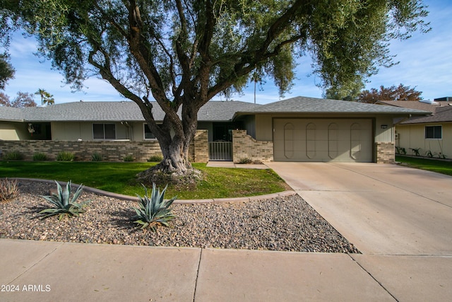 single story home with a garage and a front yard