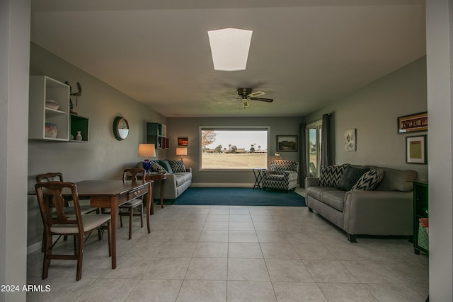 tiled living room with ceiling fan