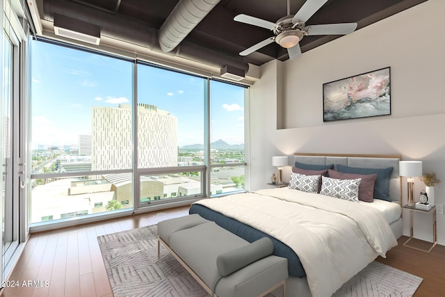 bedroom featuring multiple windows and floor to ceiling windows