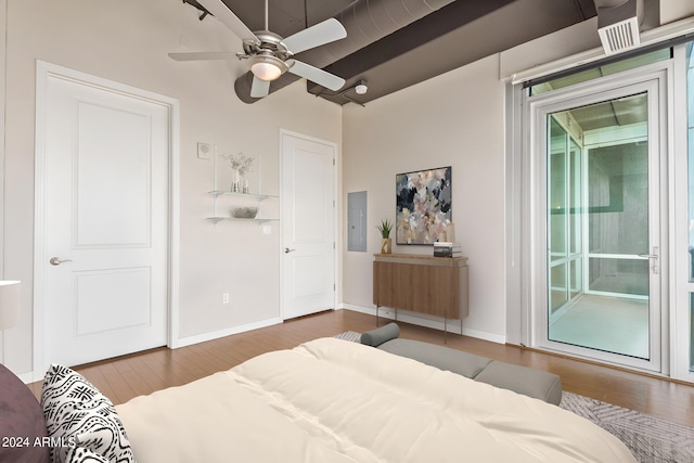 bedroom featuring wood-type flooring, access to exterior, ceiling fan, and electric panel