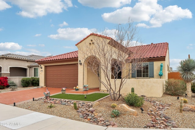 mediterranean / spanish-style home with a tile roof, a garage, driveway, and stucco siding