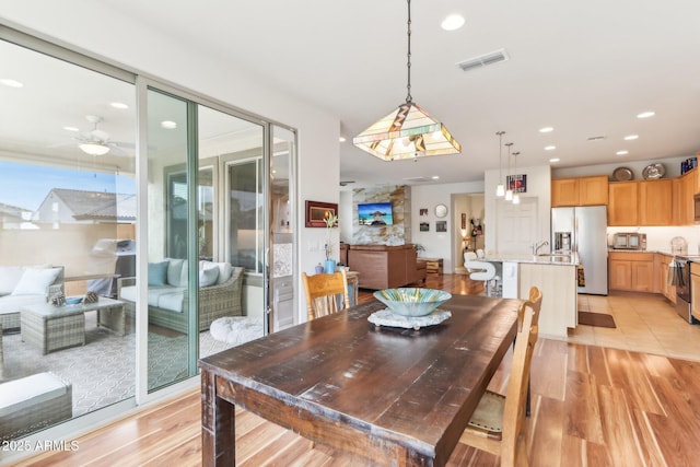 dining area featuring light wood finished floors, visible vents, recessed lighting, and a ceiling fan