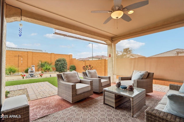 view of patio featuring an outdoor living space, a ceiling fan, and a fenced backyard