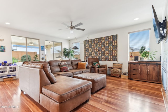 living room featuring a wealth of natural light, recessed lighting, and light wood finished floors