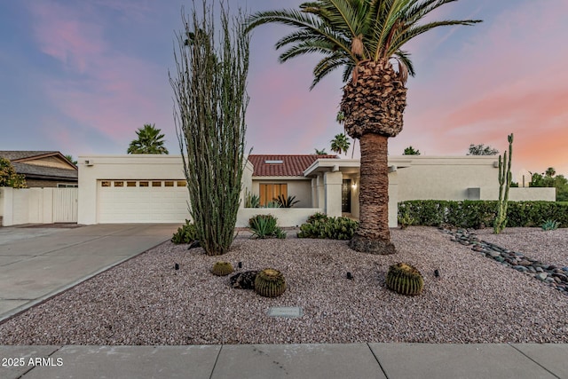 6119 E Sandra Ter, Scottsdale, AZ 85254 - view of front of home featuring stucco siding, driveway, and a garage