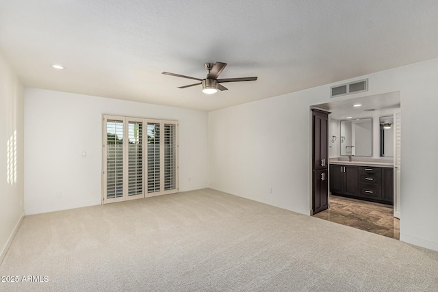6119 E Sandra Ter, Scottsdale, AZ 85254 - unfurnished bedroom featuring carpet floors, connected bathroom, baseboards, a ceiling fan, and recessed lighting