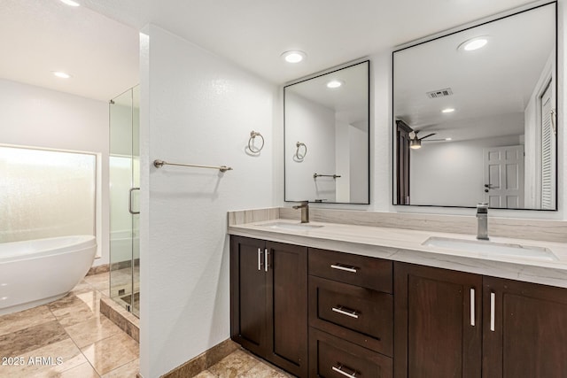 6119 E Sandra Ter, Scottsdale, AZ 85254 - full bathroom with double vanity, a stall shower, a bathtub, recessed lighting, and baseboards