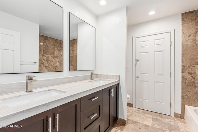 6119 E Sandra Ter, Scottsdale, AZ 85254 - bathroom featuring double vanity, toilet, and stone tile floors