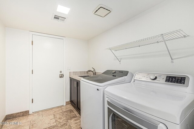 6119 E Sandra Ter, Scottsdale, AZ 85254 - laundry room with cabinet space, independent washer and dryer, baseboards, and light stone finish flooring