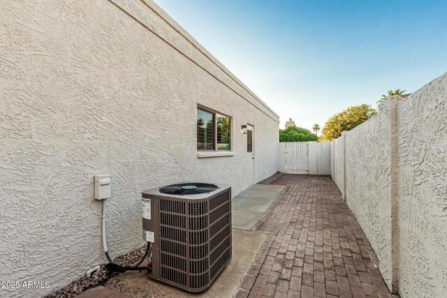6119 E Sandra Ter, Scottsdale, AZ 85254 - view of side of home with central AC unit, stucco siding, a fenced backyard, and a patio area