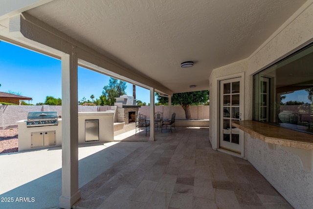 6119 E Sandra Ter, Scottsdale, AZ 85254 - fenced backyard with an outdoor stone fireplace and a patio area