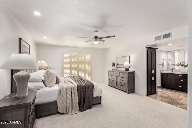 6119 E Sandra Ter, Scottsdale, AZ 85254 - bedroom with light colored carpet, ensuite bathroom, ceiling fan, and recessed lighting