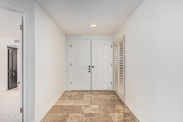 6119 E Sandra Ter, Scottsdale, AZ 85254 - hall featuring baseboards and light stone finish floors