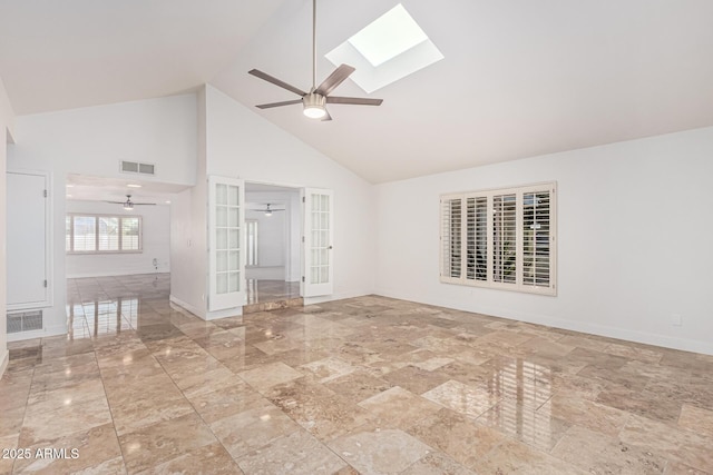 6119 E Sandra Ter, Scottsdale, AZ 85254 - empty room with ceiling fan, high vaulted ceiling, french doors, a skylight, and baseboards
