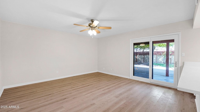 unfurnished room featuring baseboards, a ceiling fan, and light wood-style floors