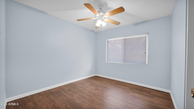 unfurnished room with dark wood-style floors, ceiling fan, and baseboards