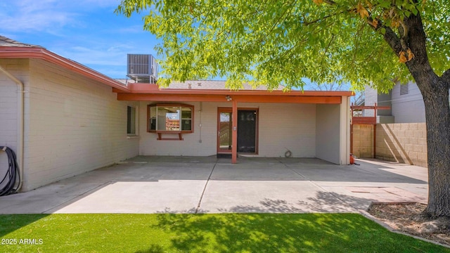 back of house with a patio area, fence, and central AC