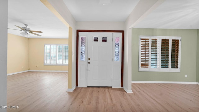 entrance foyer with light wood-style flooring and baseboards