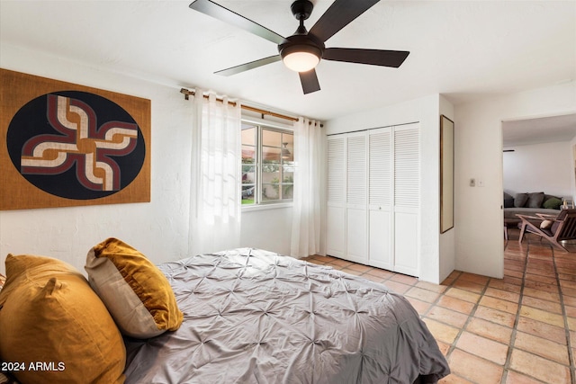 bedroom with ceiling fan and a closet