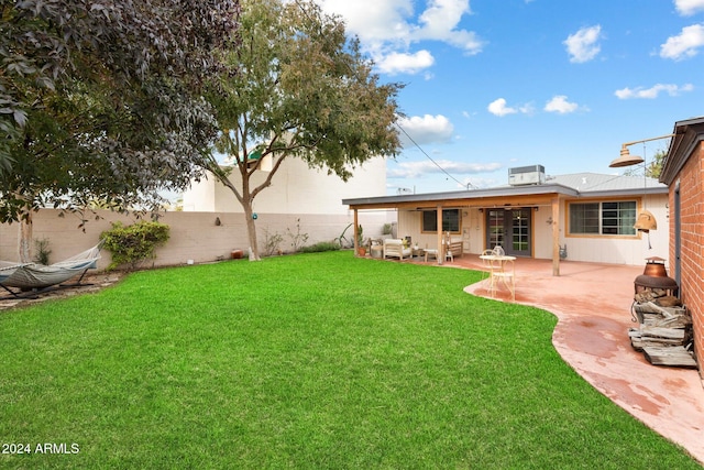 view of yard featuring french doors, an outdoor living space, and a patio