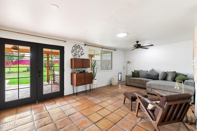 tiled living room with ceiling fan and french doors