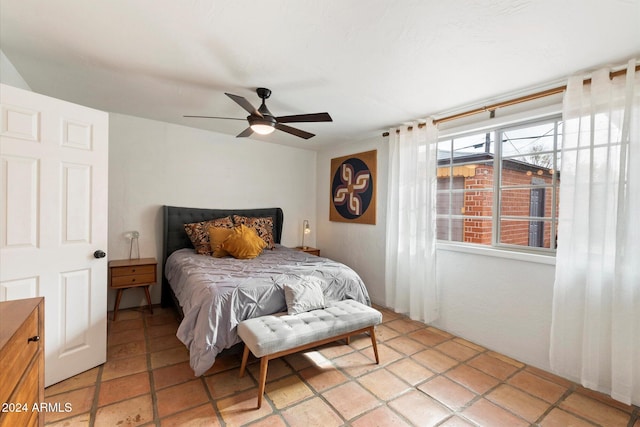 tiled bedroom with ceiling fan