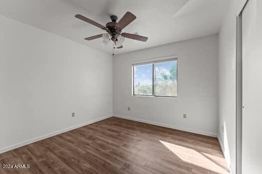 unfurnished room featuring ceiling fan and hardwood / wood-style floors