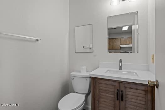 bathroom with vanity and toilet