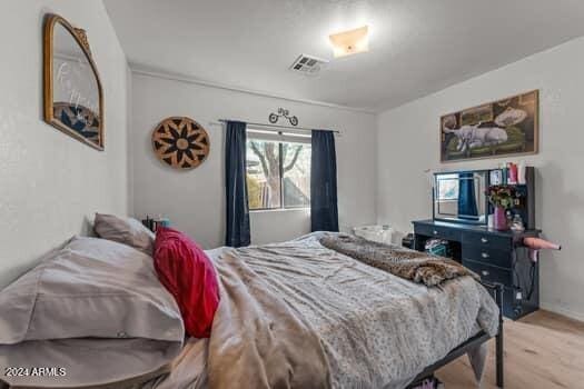 bedroom with light hardwood / wood-style floors