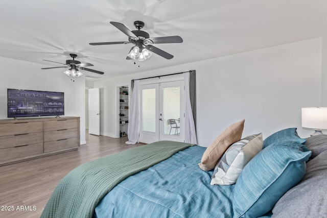 bedroom with access to exterior, french doors, light wood-type flooring, and ceiling fan