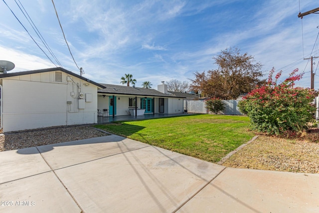 back of property featuring a porch and a lawn