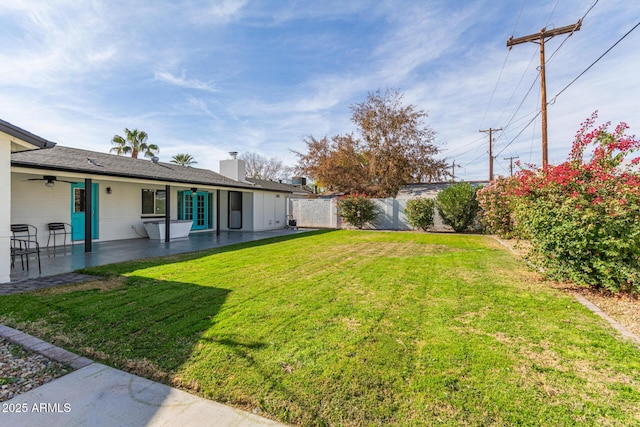 view of yard with a patio area and ceiling fan