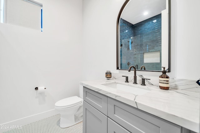 bathroom featuring tile patterned flooring, vanity, and toilet